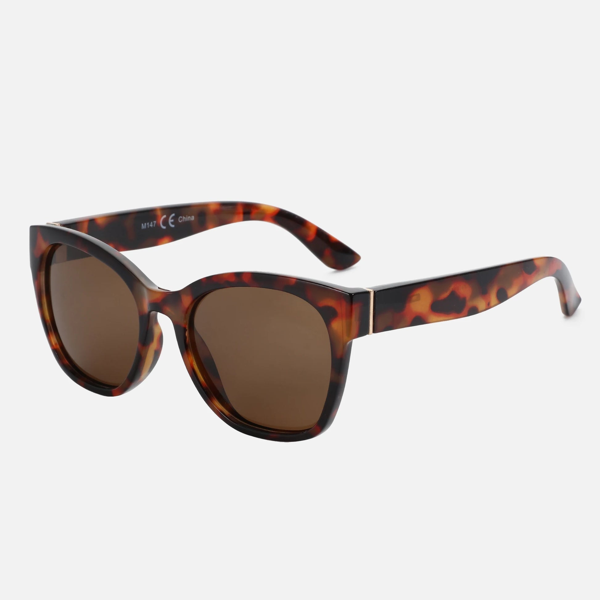 Sunglasses with tortoiseshell frame and brown lenses on a white background