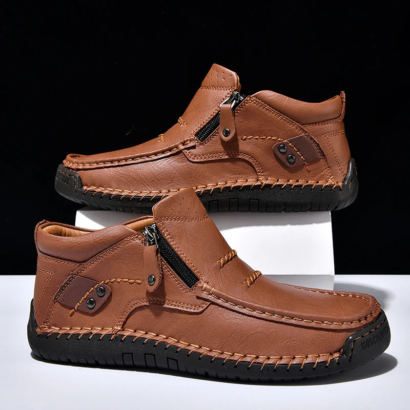 Pair of brown leather shoes with zippers on a white background