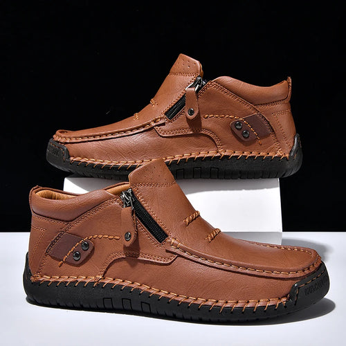 Pair of brown leather shoes with zippers on a white background