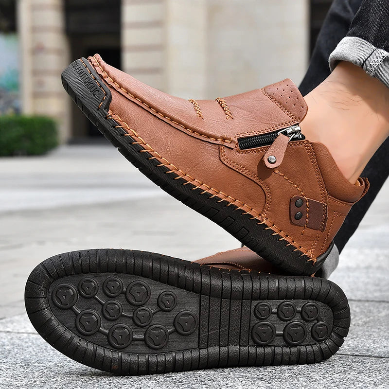 Brown leather boot with a zipper on a blurred background