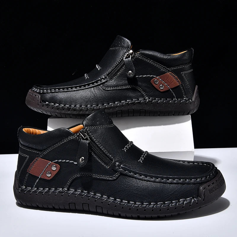 Black leather shoes with brown accents on a white and black background