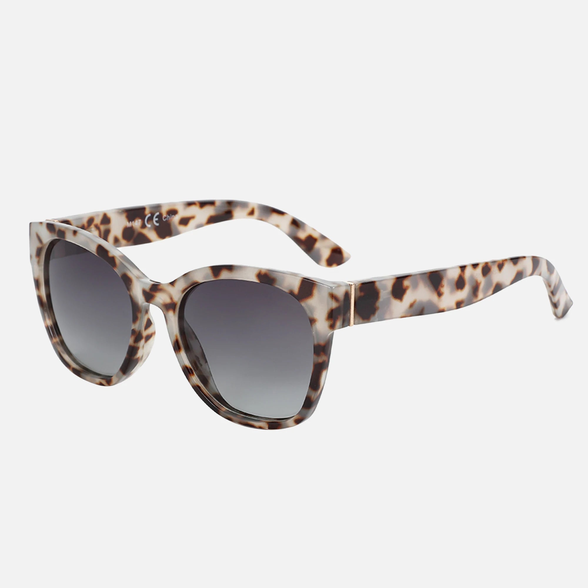 Sunglasses with tortoiseshell frame and dark lenses on a white background