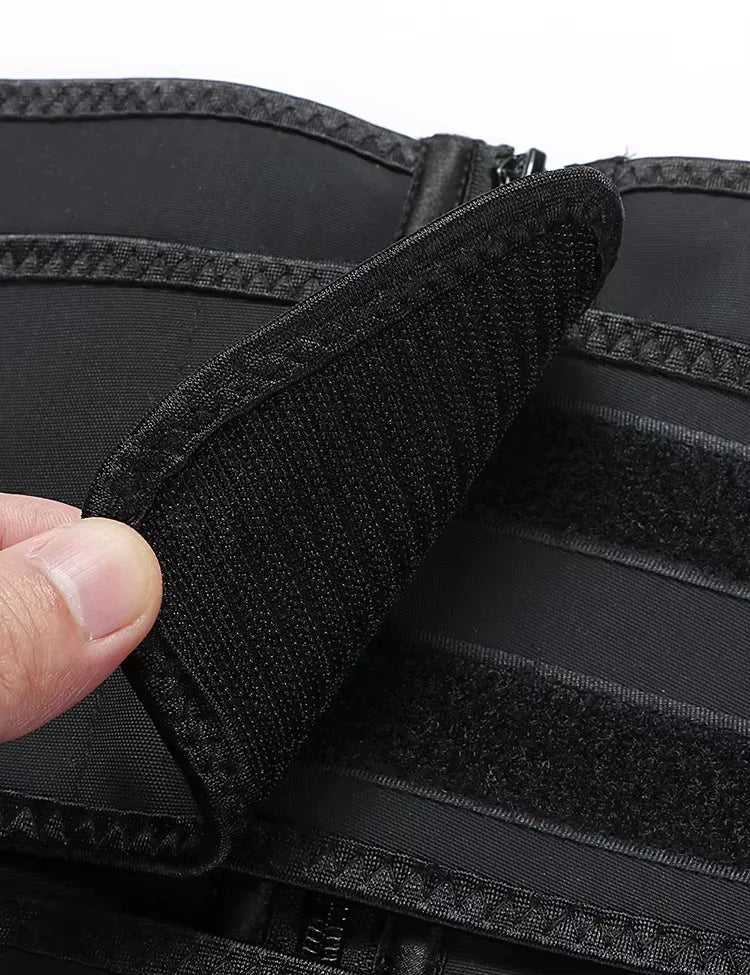 Close-up of a black tactical vest with a hand touching the material