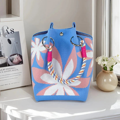 Blue tote bag with floral design on a white surface