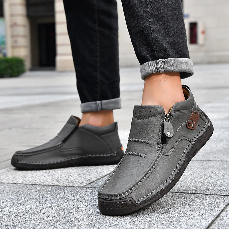 Gray loafers worn by a person on a pavement background