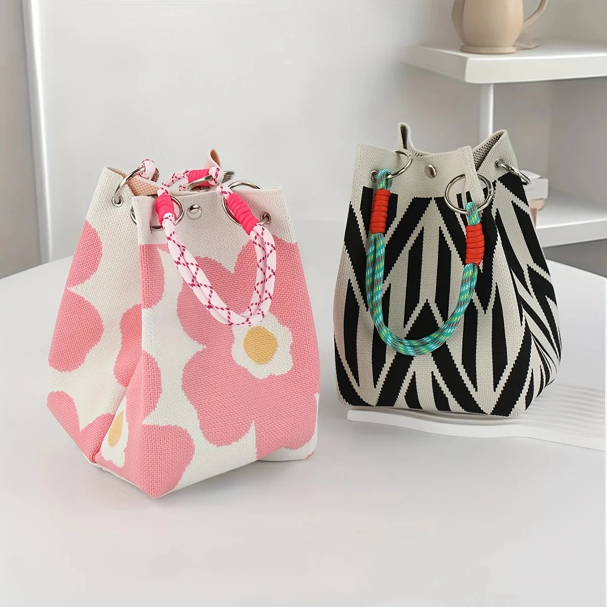 Two small handbags with floral and zebra pattern on a white surface.