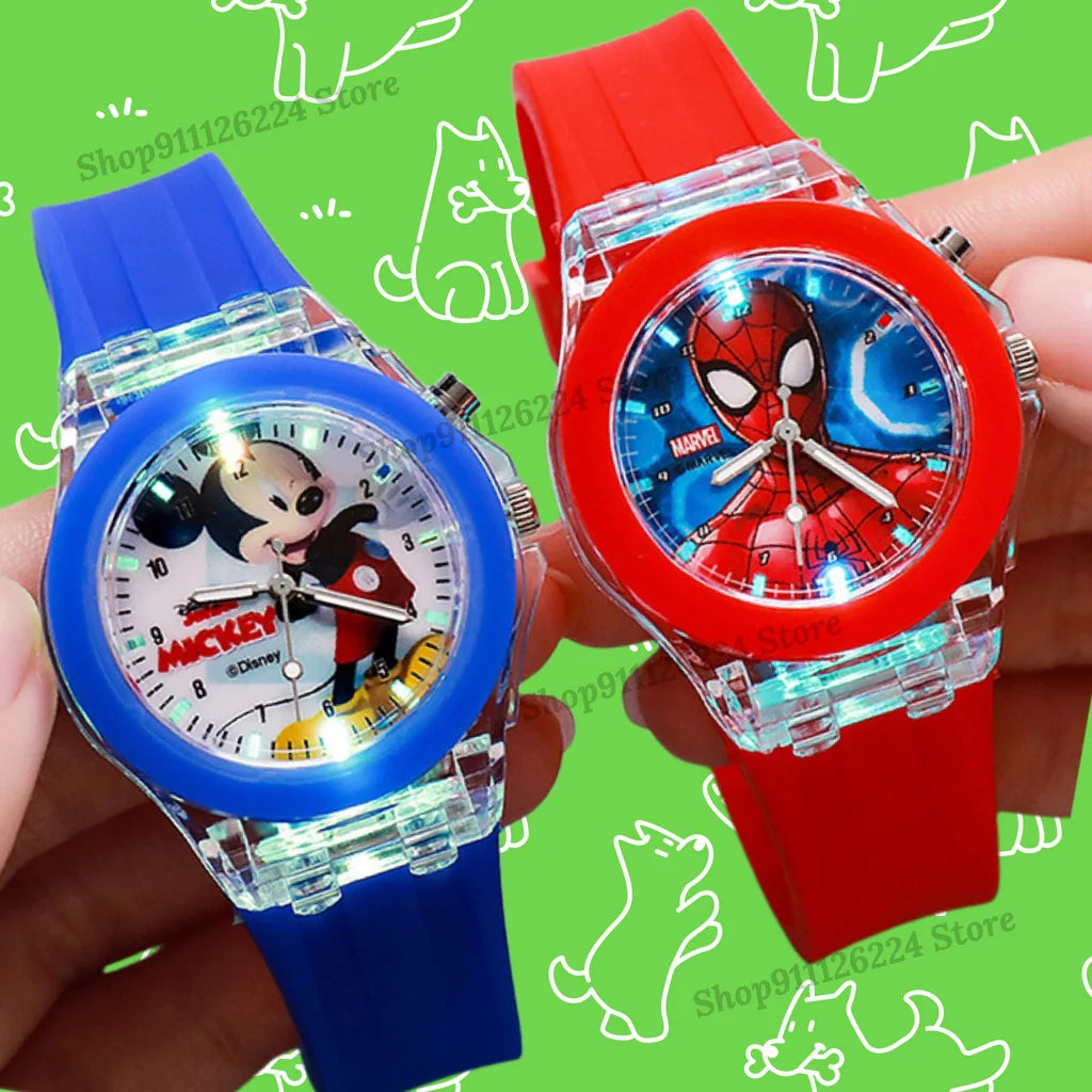 Two children's watches, one with Mickey Mouse and the other with Spider-Man, held against a green background.